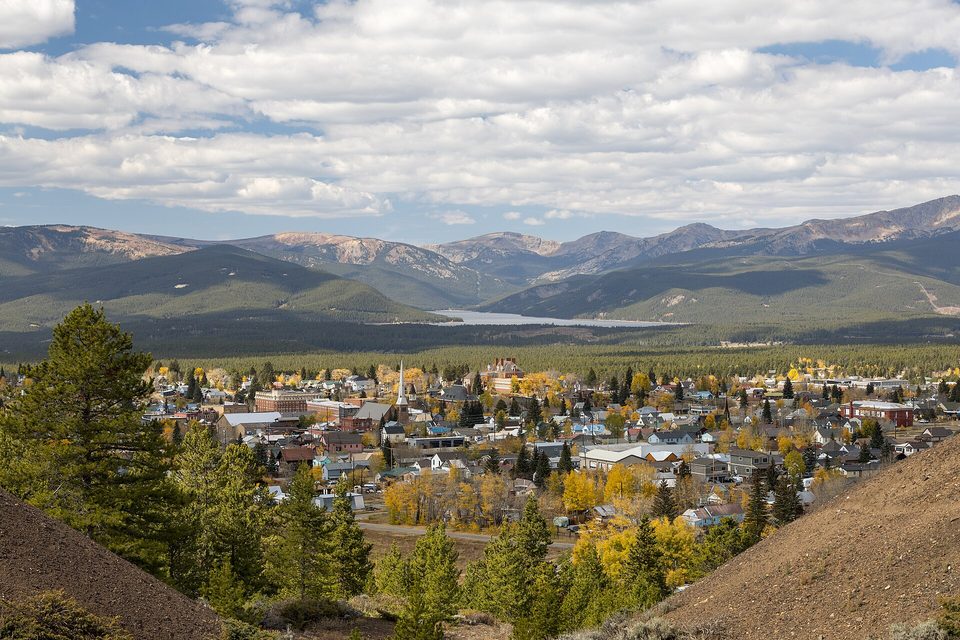 Leadville's church steeples and brick buildings in fall color with Turquoise Lake and the Sawatch Range beyond